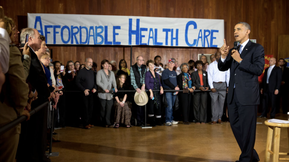 Obama speaks to crowd about Obamacare in front of "Affordable health care" banner